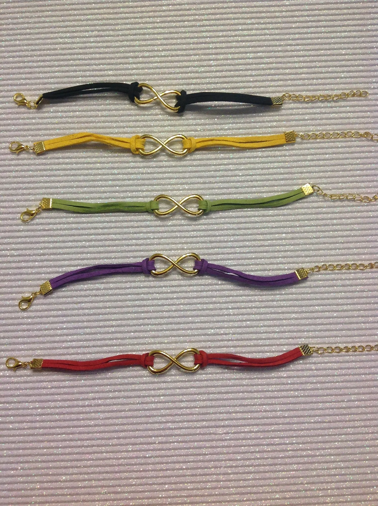 Goldtone infinity charm bracelets.